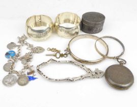 A collection of hallmarked silver to include a small charm bracelet, a hinged bracelet, a small