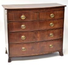 A George mahogany bow-front chest of two over three drawers with oval brass swing handles, 98 x