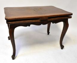 An early 20th century oak draw-leaf dining table with shaped top raised on cabriole supports to