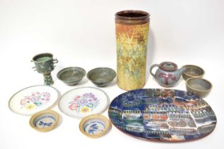 A collection of studio ceramics, including a stylised platter, signed 'Linda ?', a tall