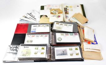 A quantity of first day covers contained within three albums and a quantity of loose examples.