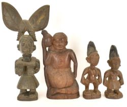 Four late 19th early/20th century carved wooden African figures, three representing fertility,