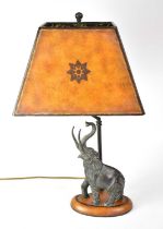 A figural table lamp with bronzed resin elephant figure raised on an oval plinth, height including