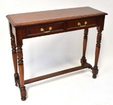 A modern mahogany side table with two drawers, on turned supports and cross-stretcher, 90 x 36 x