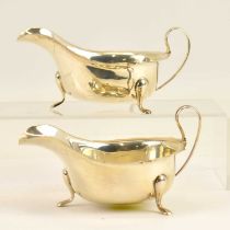 VINERS; a pair of George V hallmarked silver sauce boats with hoop handles and wide mouths, each