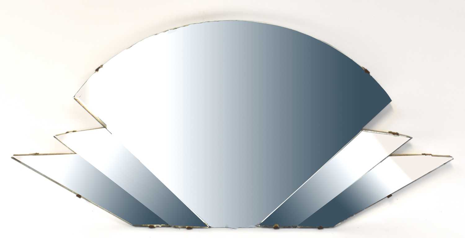 A circular wall mirror with bevelled plate and chrome swivel frame, 52 x 60.5cm, and a further Art