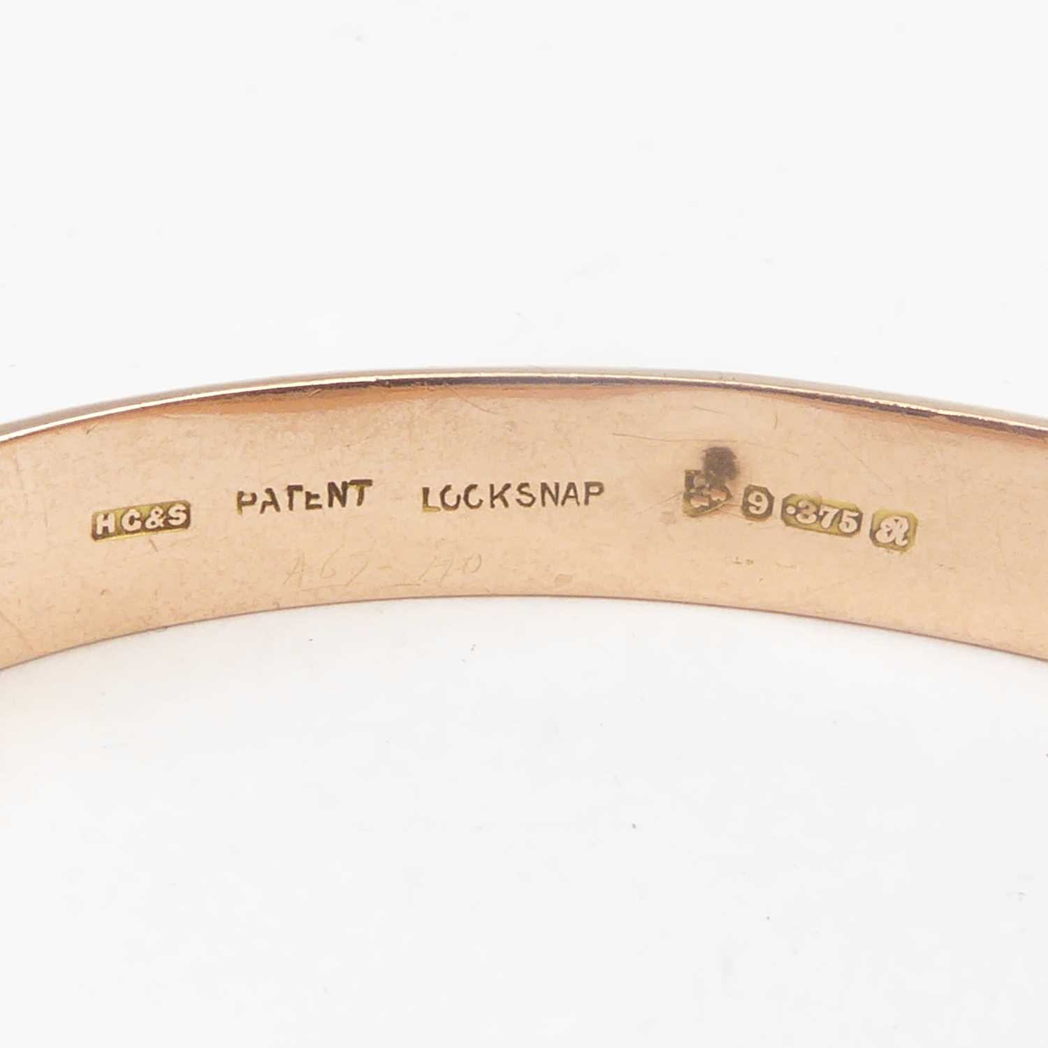 A 9ct rose gold hinged bracelet with safety chain, diameter 6.3cm, approx. 11g. Condition Report: - Image 2 of 3