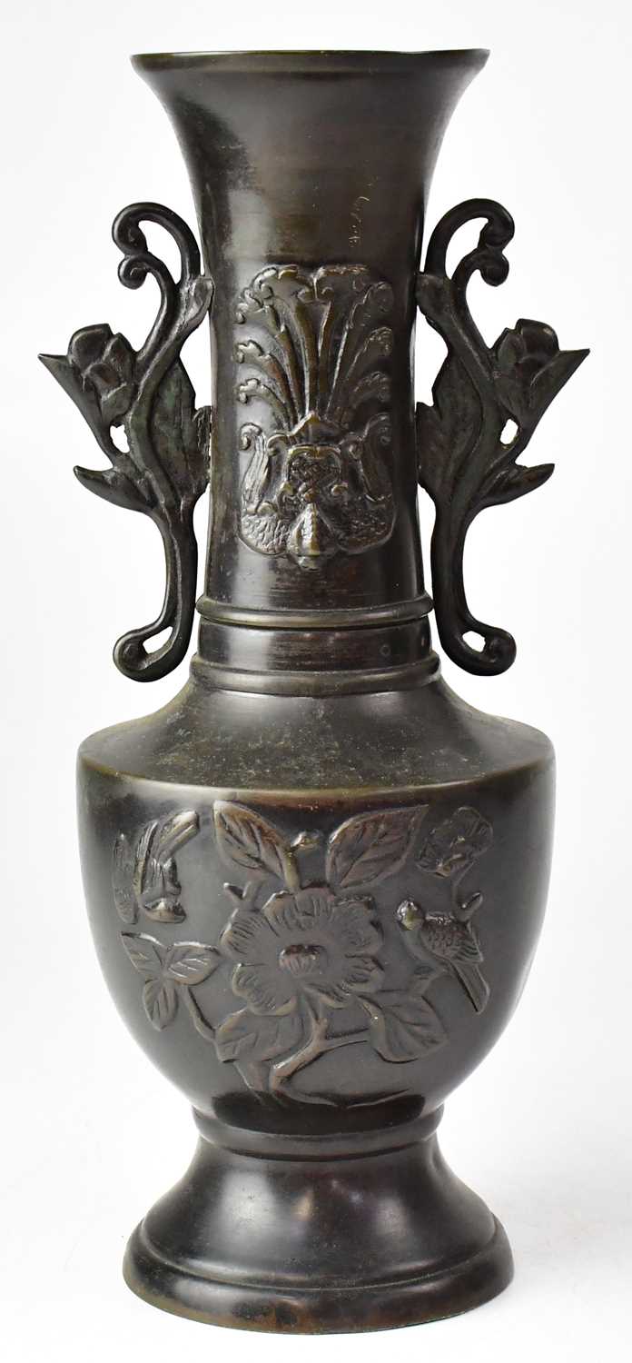 A Meiji period Japanese bronze vase with embossed decoration, height 30cm.