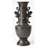 A Meiji period Japanese bronze vase with embossed decoration, height 30cm.