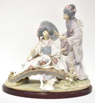LLADRÓ; 'Springtime in Japan' figure group depicting two Geishas on a bridge, mounted on wooden