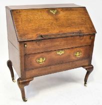 A George III oak bureau of small proportions, with fitted interior, over single drawer, raised on