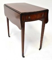 A reproduction mahogany line inlaid Pembroke drop-leaf table, with shaped top above single frieze