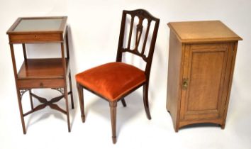 An Edwardian mahogany bijouterie table, with square glass hinged top above an undertier with