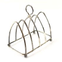 LEVI & SALAMAN; a George V hallmarked silver four-slice toast rack with Gothic arched frame, 9 x