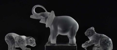LALIQUE; three figures comprising a frosted elephant on clear base, and two cheetah cubs, height