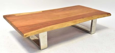 A contemporary natural cut timber coffee table raised on chrome supports, 26 x 115 x 62cm.