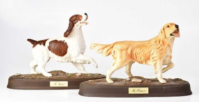 BESWICK; two matt glazed figures of dogs raised on naturalistic plinths, with applied brass-effect