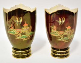 CARLTON WARE; a pair of 'Rouge Royale' vases with chinoiserie decoration, each on a circular foot,