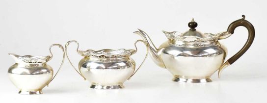 WALTER & CHARLES SISSONS; an Edwardian hallmarked silver three-piece tea service with pierced