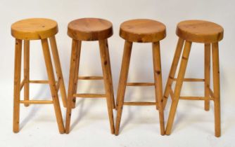 Four contemporary pine bar stools, with round tops raised on turned stretchered supports (4).