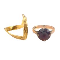 Two 9ct gold rings comprising a wishbone, size P, approx. 2.5g and one set with red stone, size N,