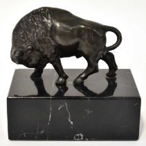 A 19th century Continental bronze model of a buffalo, modelled with its head bowed, mounted on a