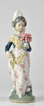 LLADRÓ; a Valencia figure of a young lady with a bunch of flowers, height 24cm. Condition Report: