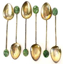 Six Chinese silver teaspoons, each with claw set spinach green jade carved oval panel finials and