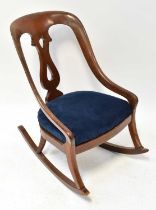 A 19th century mahogany rocking chair with blue velour drop-in seat.