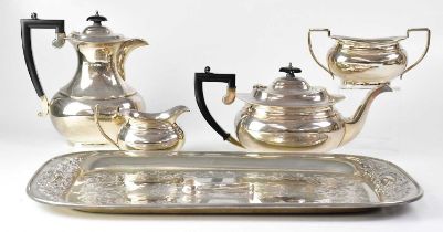 WILLIAM ADAMS LTD; a George V hallmarked silver four piece tea service of oval baluster form,