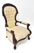 A reproduction carved mahogany framed spoon back open arm elbow chair, raised on carved cabriole