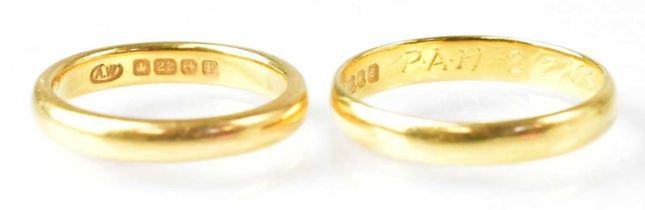 Two 22ct yellow gold wedding bands, sizes Q and L, the larger with inscription to interior of shank,