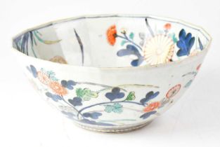 A Japanese bowl in the Imari palette, painted with peonies and flowers on a white ground, diameter