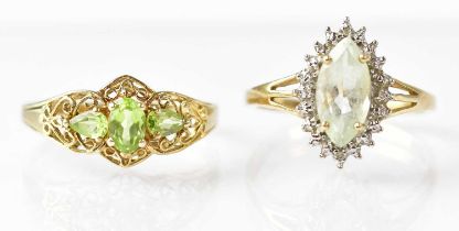 A 9ct gold three-stone peridot ring with filigree decoration to the shoulders, size T, a 9ct gold