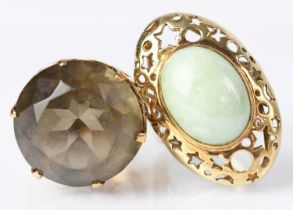 A 9ct yellow gold ring set with green hardstone, in a pierced oval mount, size Q, together with a