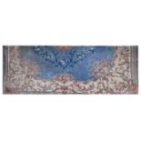 A large Chinese blue ground carpet with flowers within a cream scrolling border, 400 x 365cm.
