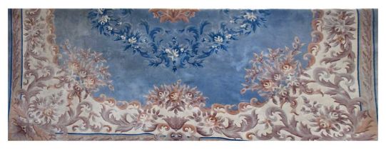 A large Chinese blue ground carpet with flowers within a cream scrolling border, 400 x 365cm.