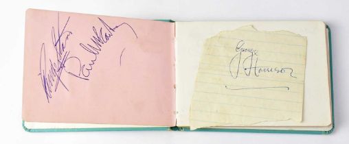 THE BEATLES; an autograph book bearing signatures of Ringo Starr and Paul McCartney to the first