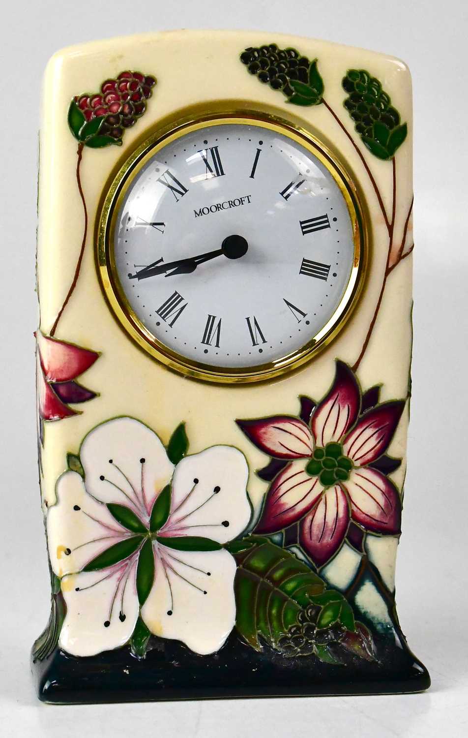 MOORCROFT; a 'Bramble Revisited' pattern mantel clock, the white enamelled dial set with Roman