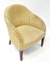 An early 20th century walnut framed tub chair upholstered in blue and white striped fabric.