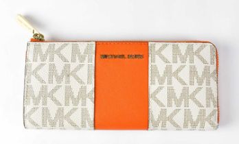 MICHAEL KORS; a studio logo print purse/wallet, with signature print in natural/orange, width 20cm.