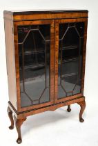 A 1940s mahogany astragal glazed display cabinet, on cabriole shell motif supports, 123 x 78 x 29cm.