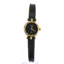 GUCCI; a ladies' dress watch, the black dial with gold hands, on a black strap.