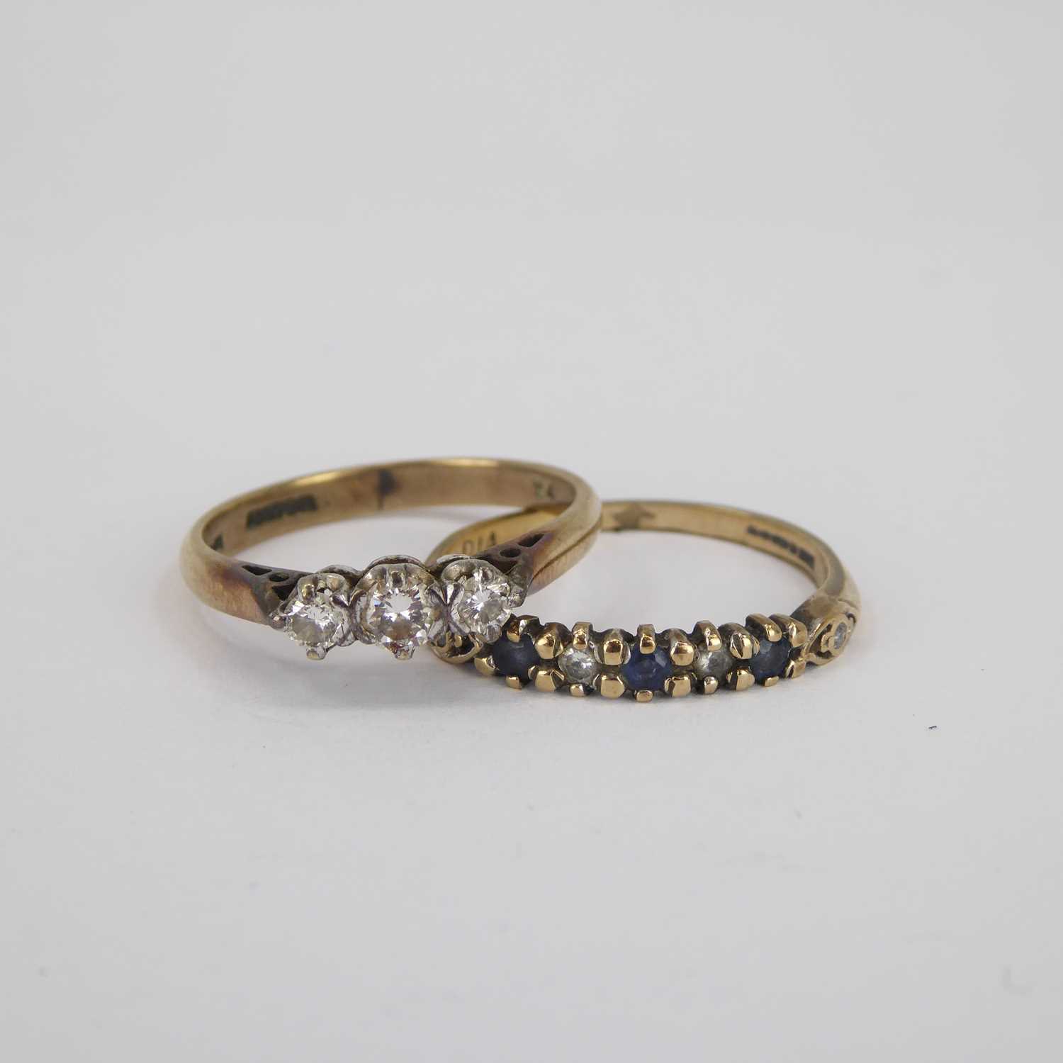 A 9ct gold ring with three small claw set graduated diamonds and a 9ct gold half eternity diamond - Image 2 of 4