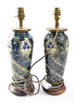 DOULTON LAMBETH; a pair of lamp bases of shouldered tapering form, tube lined with Art Nouveau style