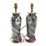 DOULTON LAMBETH; a pair of lamp bases of shouldered tapering form, tube lined with Art Nouveau style