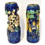 A pair of Chinese-style Shiwan pottery vases modelled with figures in a tree, on a blue ground