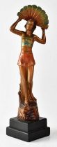 An early 20th century painted spelter figure of a young female dancer holding a fan behind her head,