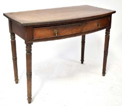 A 19th century mahogany bow-front side table with single drawer, on turned legs, 73 x 99 x 54cm.