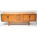 G-PLAN; a 1960s teak sideboard from the Fresco range, the central bank of four drawers flanked by